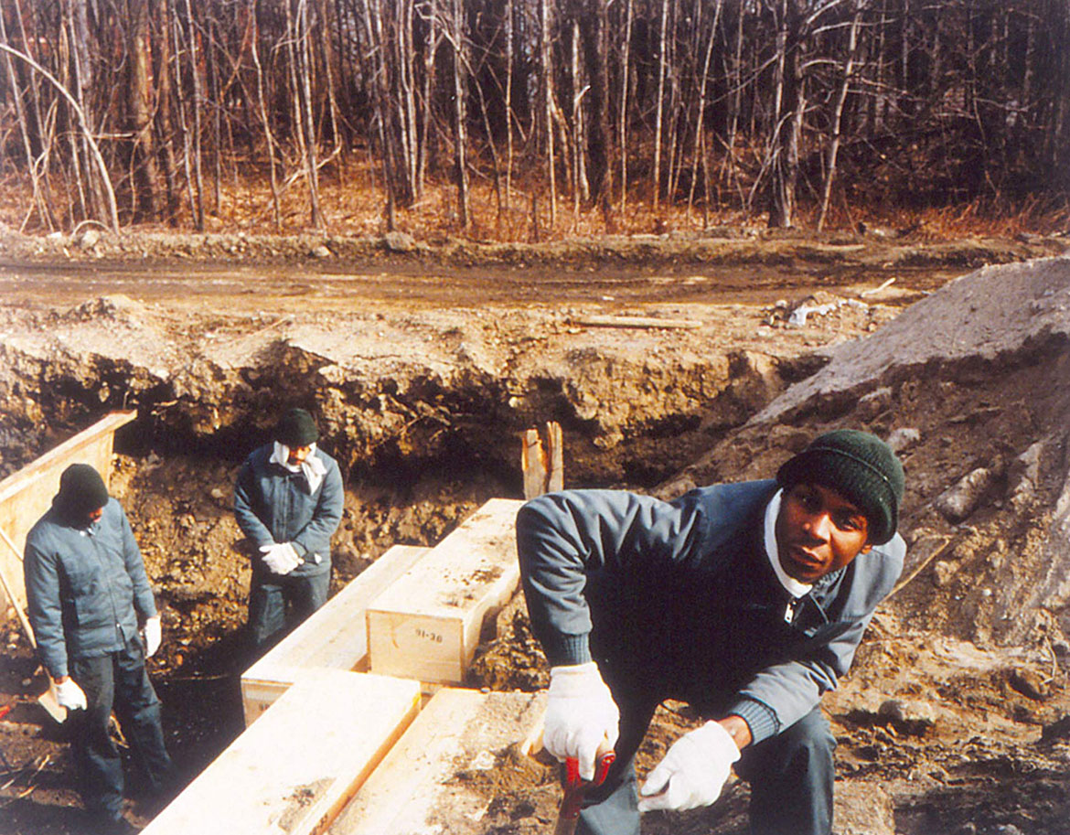 Inmates pause during a burial